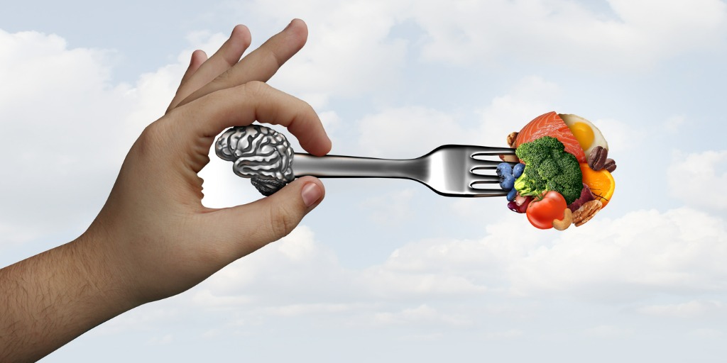 hand holding a fork with a brain at one end and food at the other