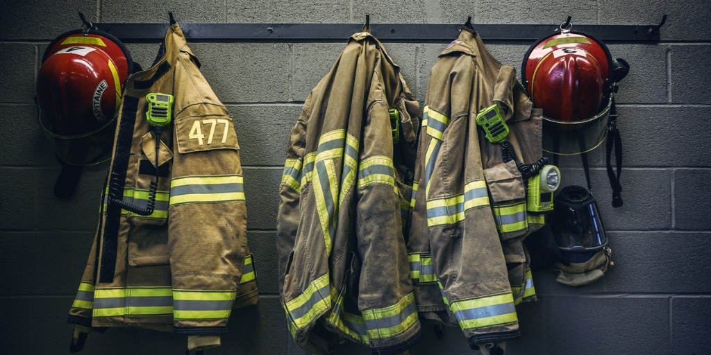 firefighter jackets hanging from hooks