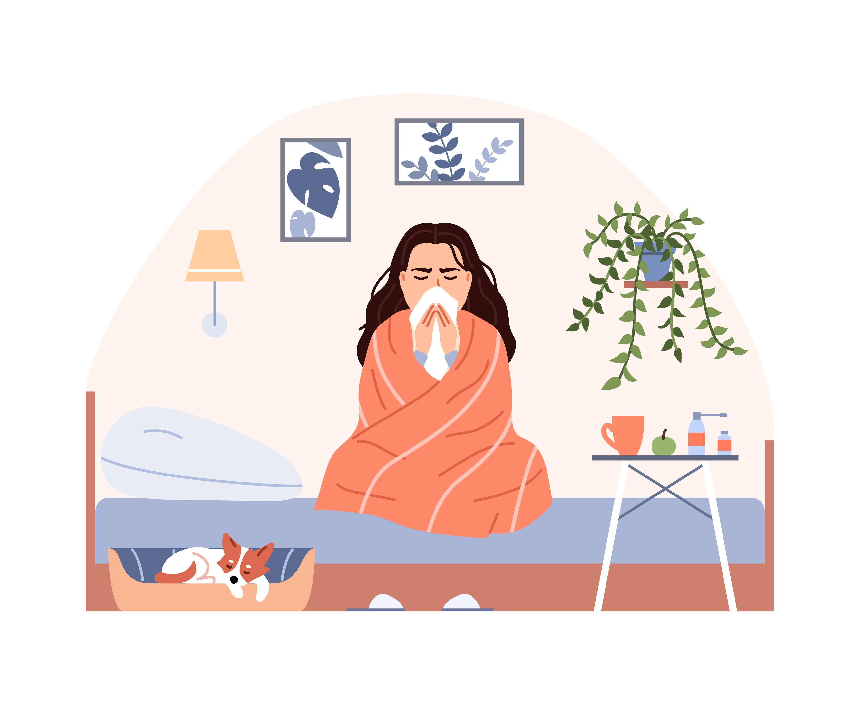 woman blowing her nose on bed wrapped in blanket