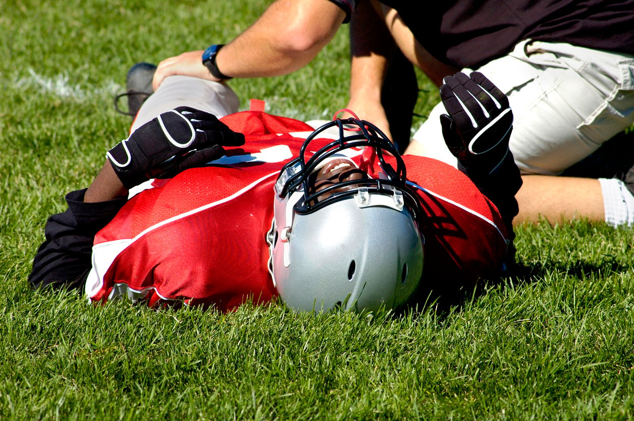 football player lying down on field